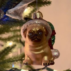 Pug Christmas ornament hanging on a tree
