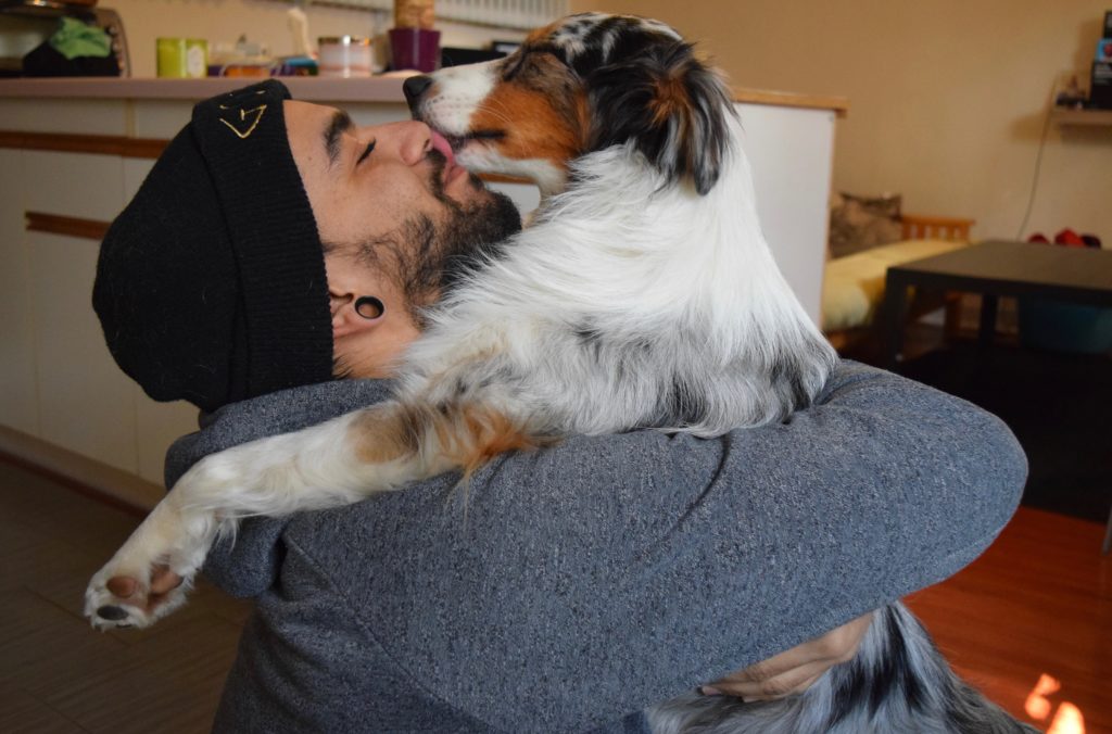 Man hugging dog on the floor